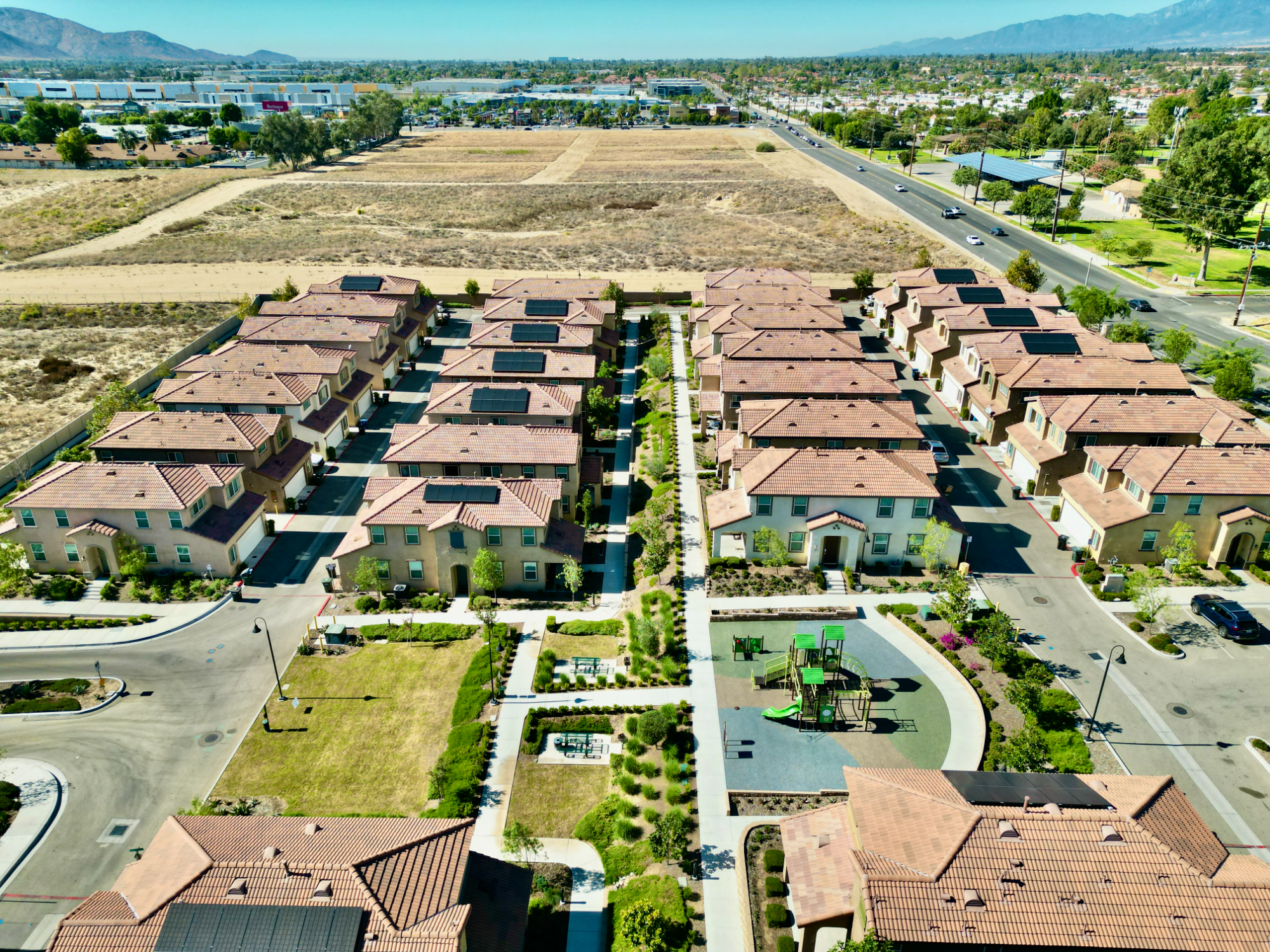 Single-story home with a palm tree and a green front lawn in Fontana, California